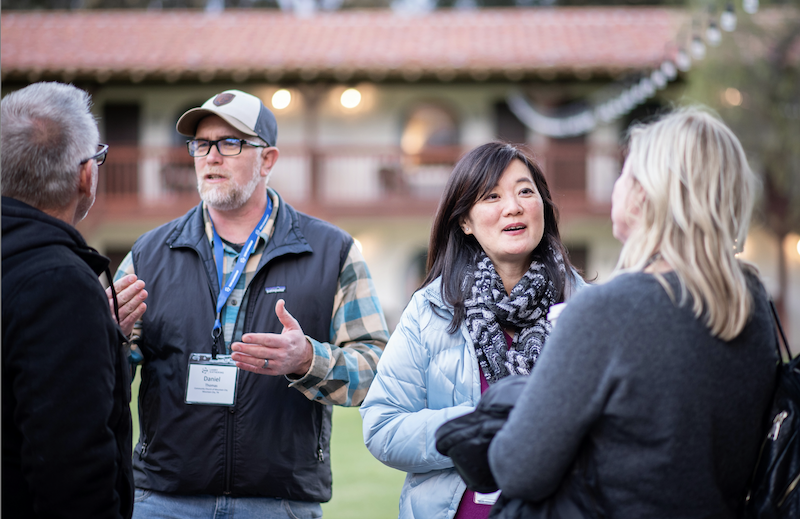 Real community workshop or drop-in session – people talking, community hall, sticky notes.
